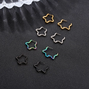 Detail of star-shaped stainless steel hoop earrings in gold, silver, rainbow, and black