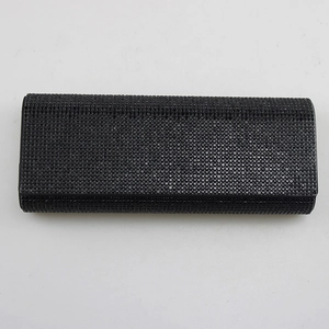 Close-up of black rhinestone studded glasses case showing detailed texture and craft.