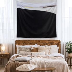 Detailed texture of minimalist landscape tapestry hanging in a cozy boho bedroom