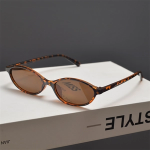 Detail of vintage oval leopard print sunglasses with brown lenses on a style book