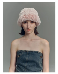Close-up detail of soft pink faux fur bucket hat material and plush knit texture