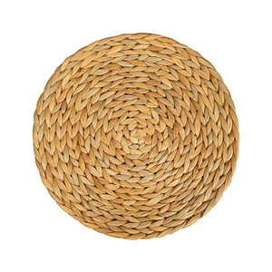 Handwoven round water hyacinth placemat with natural straw texture and heat resistance