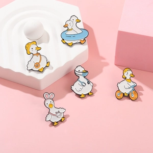 Set of five cute cartoon enamel duck brooches in diverse creative styles and bright colors
