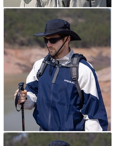 Outdoor detail of a navy wide-brim sun hat and breathable windbreaker jacket