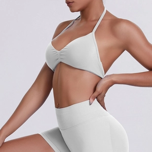 Close-up detail of seamless ribbed knit texture on high-waist yoga shorts and sports bra