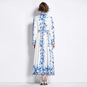 White long-sleeve maxi dress with blue floral print and standing collar, back view model