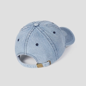 Close-up of vintage metal buckle and adjustable denim strap on the baseball cap