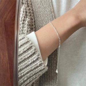 Minimalist 925 sterling silver geometric fine chain bracelet on a female wrist