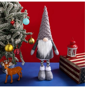 Detail of Christmas gnome plush with grey hat and white beard in festive indoor setting