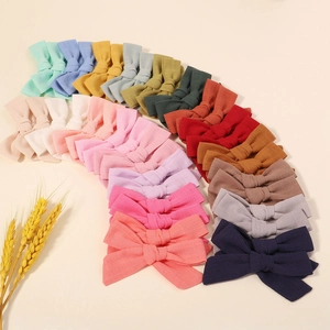 Detailed collection of colorful linen bow hair clips in various pastel and neutral shades