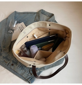 Top view of large canvas tote bag showing spacious interior with tablet and umbrella
