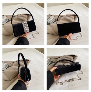 Elegant black velvet evening bag with sparkling rhinestone decor and silver chain strap