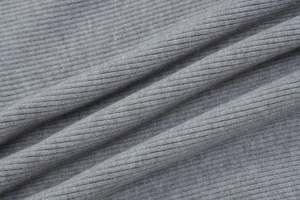 Detailed macro view of the grey ribbed knit fabric texture and soft elastic weaving material
