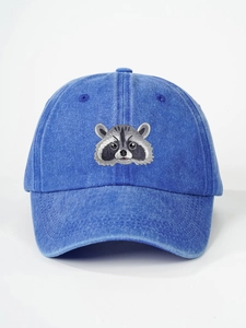 Close-up of raccoon embroidery on a blue washed denim vintage baseball cap detail