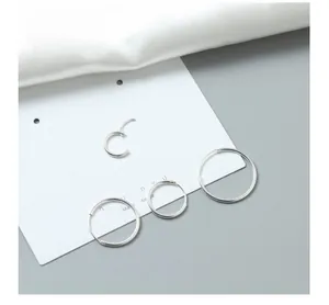 Set of four minimalist S925 sterling silver hoop earrings in various sizes on display