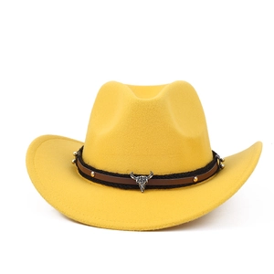 Detail of yellow felt cowboy hat featuring brown leather band and silver bull head emblem
