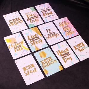 Detail of assorted inspirational mini cards with gold foil lettering on black background