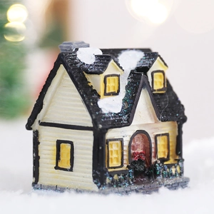 Luminous Christmas miniature house with snowy roof and festive interior lighting decor