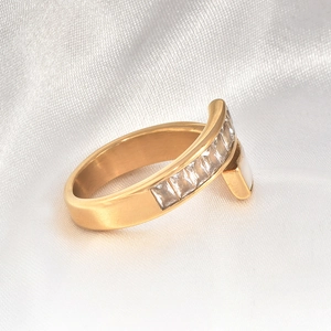 Detailed view of 18k gold plated ring with white shell inlay and sparkling cubic zirconia