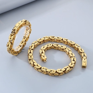 Close-up of Byzantine style gold-plated stainless steel chain necklace and bracelet set