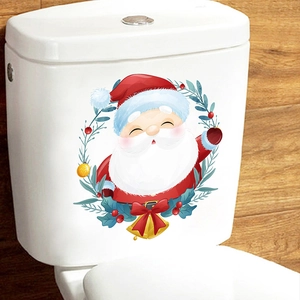 Close-up of Santa Claus and Christmas wreath decals applied on a white toilet tank lid
