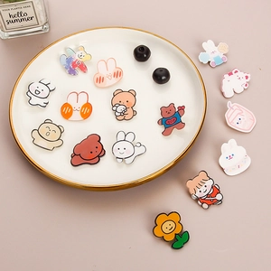 Kawaii cartoon acrylic badges with cute rabbit and bear shapes on a decorative dish