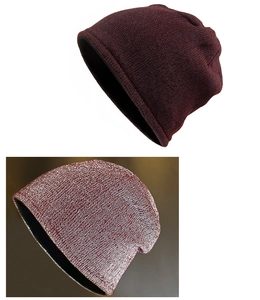Detail of burgundy thick knitted beanie showing fine texture and warm fleece lining