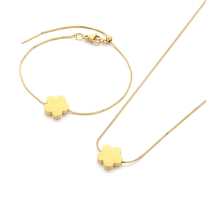 Golden snake chain jewelry set with minimalist flower pendants on necklace and bracelet