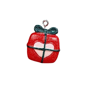 Christmas resin gift box pendant with green ribbon and pink heart on white background