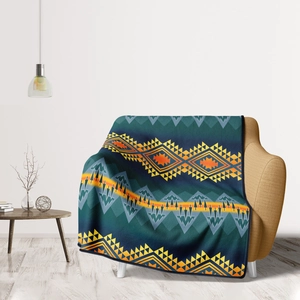 Detail of tribal geometric flannel blanket draped over an armchair in a cozy home setting