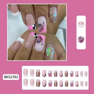 Detail of pink French press-on nails with black butterfly and checkered patterns