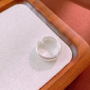 Vintage brushed silver ring with small zircon stones on textured open adjustable band