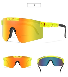Detail of yellow cycling sunglasses with red splatter and orange mirrored lenses