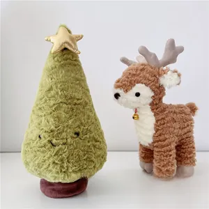 Close-up of soft sherpa plush Christmas tree and reindeer dolls with golden details