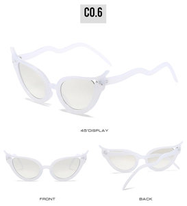 Detail of white cat eye sunglasses featuring unique wavy temples and rhinestone accents