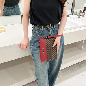 Chic burgundy leather envelope clutch with classic canvas pattern and gold metal accent