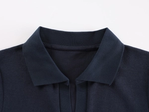 Detailed close-up of dark blue knit polo shirt lapel and fine fabric texture