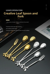 Close-up of gold and silver leaf-shaped stainless steel spoons with mirror finish