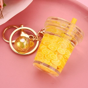 Detail of creative lemon tea keychain with floating lemon slices and gold lobster clasp