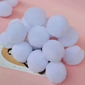 Close-up of fluffy white plush balls for DIY crafts and Christmas clothing decorations