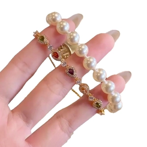 Elegant gold bracelet set with colorful teardrop zircons and white lustrous pearls