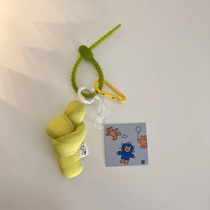 Macro shot of green fabric knot pendant with yellow carabiner and acrylic chain detail