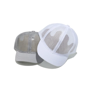 Detail view of mesh baseball caps in dark grey and white with breathable mesh texture