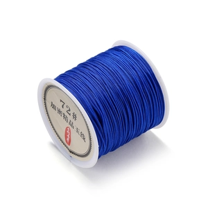 Close-up of 0.8mm blue polyester cord on spool for DIY jewelry and knotting