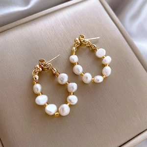 Elegant gold hoop earrings with irregular white pearls and small gold metal beads