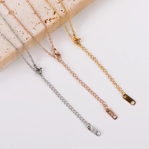 Detailed view of 18K gold and rose gold LOVE necklaces with K18 hallmarked tags