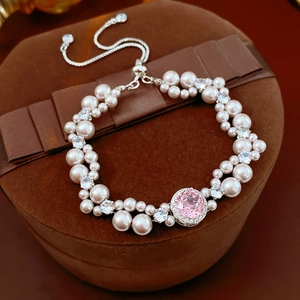 Detail of pink gemstone pearl bracelet with silver adjustable chain on velvet jewelry box