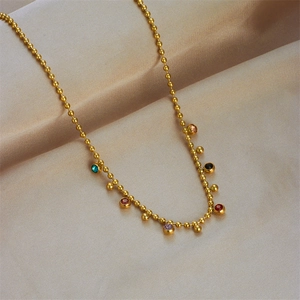 Golden beaded necklace with colorful round crystals on premium champagne silk fabric