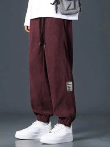 Men's loose corduroy cargo pants in burgundy red featuring side letter patches
