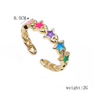 Detail view of colorful enamel star rings in gold with dimensions and 2g weight specs